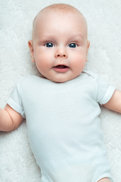 Little baby in the shirt on a carpet - Fotoğraf, Görsel