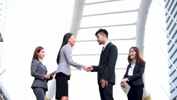 Team Business Partners shaking hands together to Greeting Start up new project. Corporate Teamwork Partnership outside office modern city as background. Businessman with Hands together. - Footage, Video