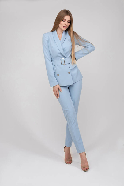 Adorable young fashion female model posing in trendy blue pantsuit full length isolated - Fotoğraf, Görsel