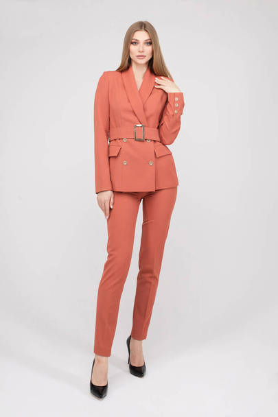 Adorable young fashion female model posing in trendy pantsuit full length isolated - Foto, immagini