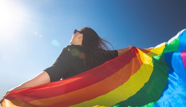 Lesbian woman with gay pride, rainbow flag, LGBTQ backgrounds with extra copy space, LGBTQ concept - Zdjęcie, obraz