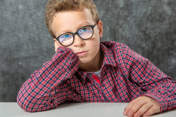 portrait of pensive cute child with a checkered shirt - Photo, Image