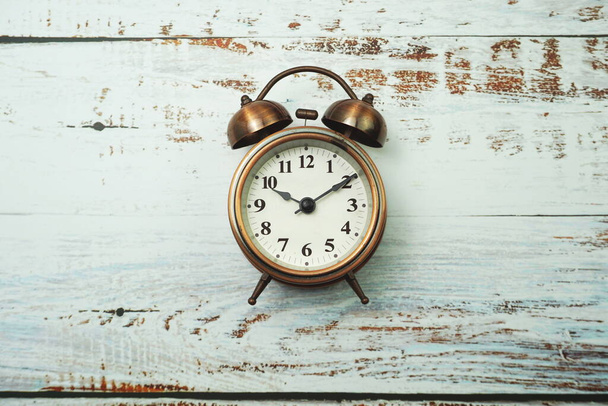 Vintage Alarm Clock And Tulip Bouquet with space copy on wooden background - Photo, Image