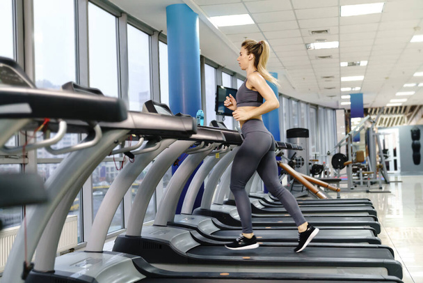 Young sporty Woman On Running Machine In Gym - Foto, Imagem