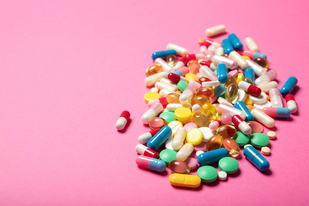 Pills and capsules on a pink background.Concept of medicine and health. - Fotó, kép