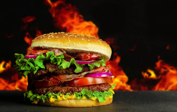 hamburger with meat and vegetables on a black background - Photo, Image