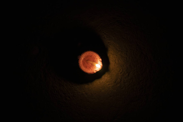 Glowing clay lamp in dark night - Happy Diwali, Light festival, Illuminated lights - Photo, Image