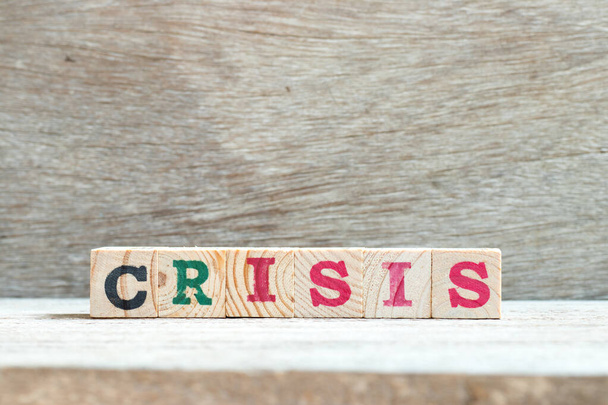 Alphabet letter in word crisis on wood background - Photo, Image
