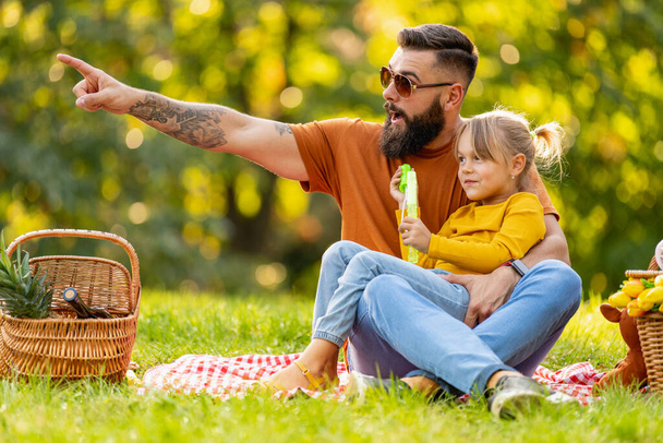 Happy family having fun together outdoor.Family,lifestyle and nature concept.Joyful family picnicking in summer park. - Φωτογραφία, εικόνα