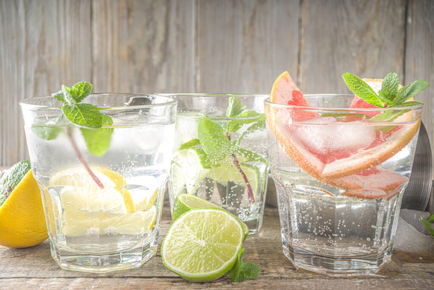 Summer detox beverage  concept. Citrus fruit drinks with ice. Healthy diet cocktail with making bar tools.  Vitamin fortified water - Фото, зображення