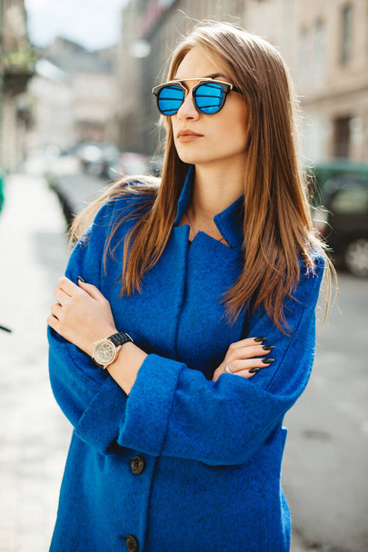 young beautiful stylish woman walking in street in blue coat, autumn fashion trend. - Photo, Image
