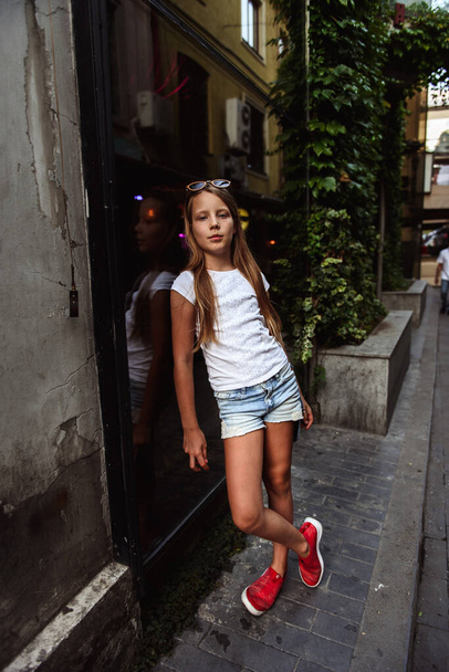 cute young girl standing on the street - Fotó, kép