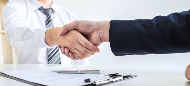 Good deal of interview, Business people and recruiter shaking hands greeting or get acquainted of conducting a job interview while sitting at the working meeting in office. - Photo, Image