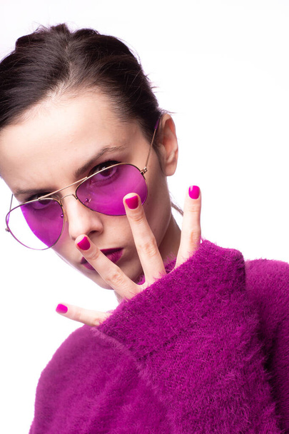 girl in a purple sweater, purple glasses with purple lipstick on her lips - Foto, imagen