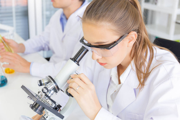 Male and female scientists working in a science laboratory with various equipment in the laboratory. - Φωτογραφία, εικόνα