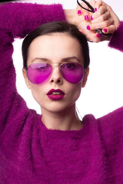 girl in a purple sweater, purple glasses with purple lipstick on her lips - Photo, image