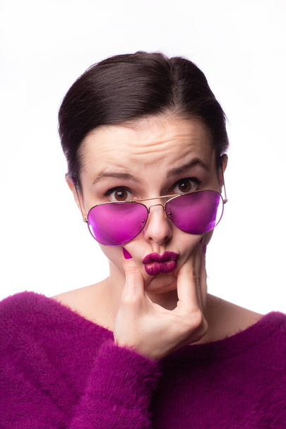 girl in a purple sweater, purple glasses with purple lipstick on her lips - Φωτογραφία, εικόνα