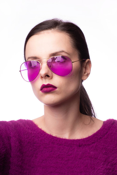 girl in a purple sweater, purple glasses with purple lipstick on her lips - Photo, image
