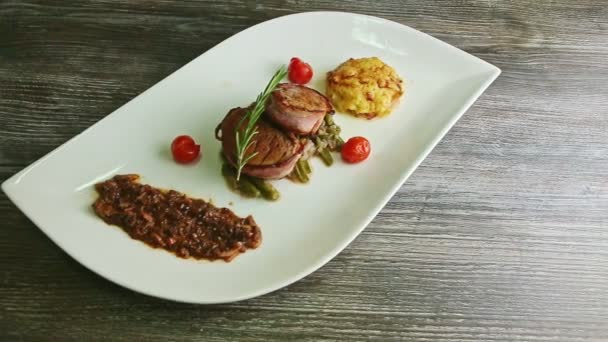 slow panorama on white restaurant dish with grilled meat - Materiał filmowy, wideo