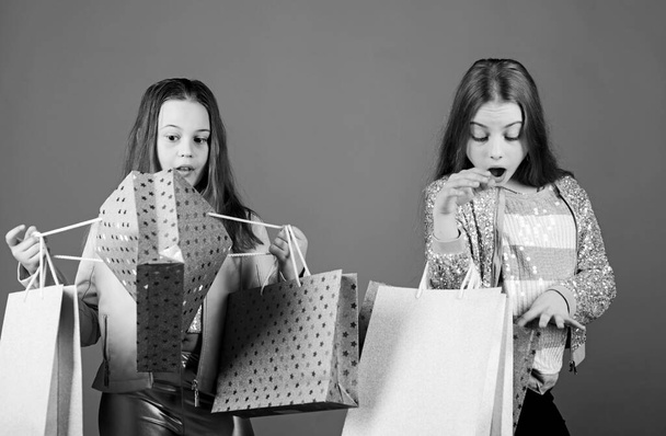 Shopping day happiness. Sisters shopping together. Buy clothes. Fashionista addicted buyer. Fashion boutique kids. Shopping of her dreams. Happy children in shop with bags. Shopping is best therapy - Valokuva, kuva