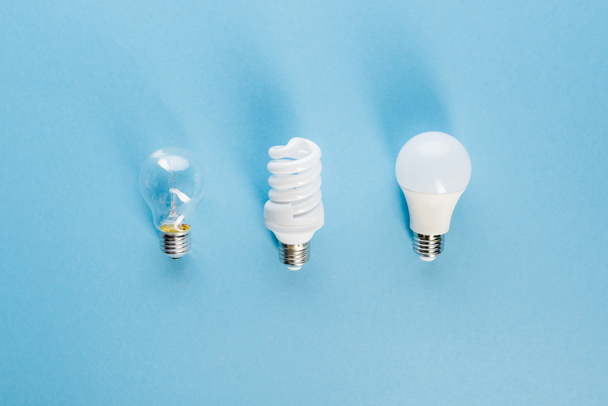 top view of different light bulbs on blue, evolution concept  - Photo, Image