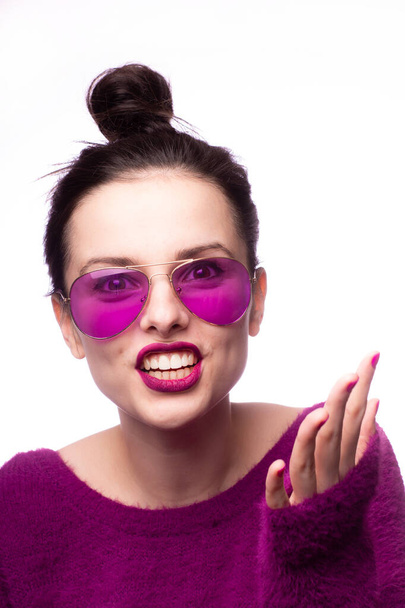 girl in a purple sweater, purple glasses with purple lipstick on her lips - Фото, зображення