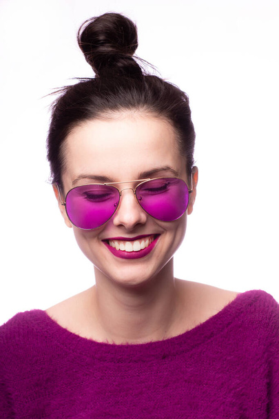 girl in a purple sweater, purple glasses with purple lipstick on her lips - Zdjęcie, obraz