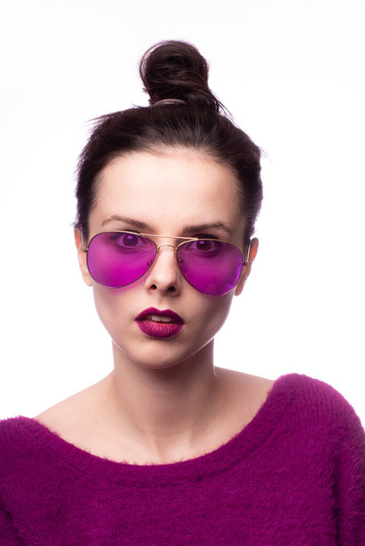 girl in a purple sweater, purple glasses with purple lipstick on her lips - Φωτογραφία, εικόνα