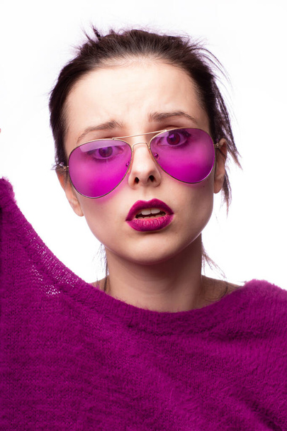 girl in a purple sweater, purple glasses with purple lipstick on her lips - Fotoğraf, Görsel