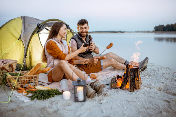 Couple at the campsite on the beach - Photo, Image