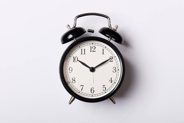 Black vintage alarm clock on white background - Fotó, kép