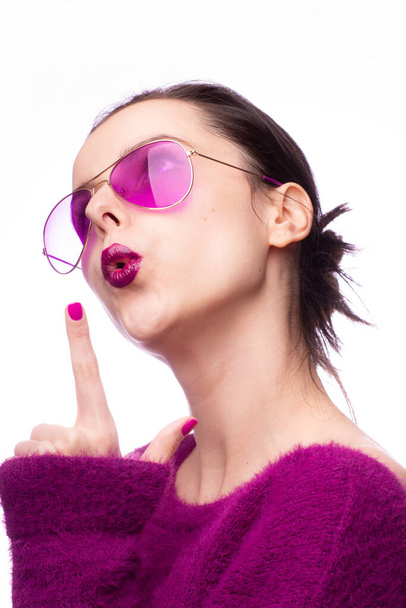 girl in a purple sweater, purple glasses with purple lipstick on her lips - Valokuva, kuva