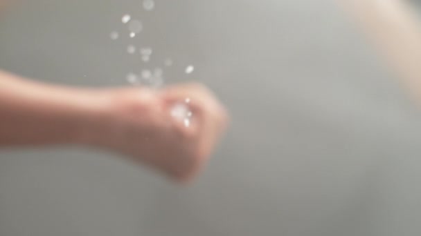 SLOW MOTION, MACRO: Unrecognizable chef sprinkles sugar crystals over the camera - Footage, Video