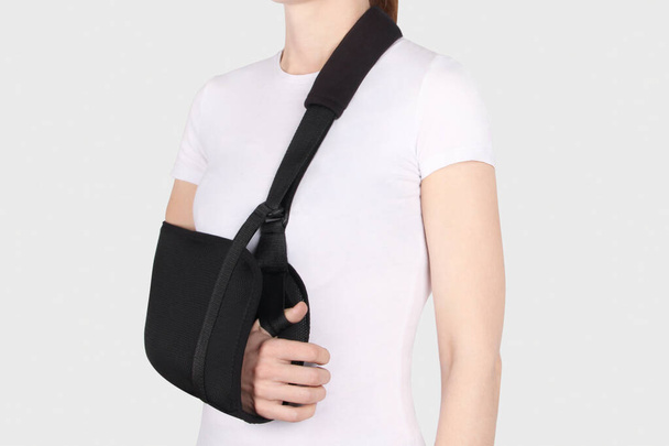 Shoulder Joint Brace. Bandage on the shoulder joint (scarf) with additional fixation. Deso's Handwrap. Supports & Immobilizers. Orthopedic medical Braces. Shoulder injury. - Photo, image