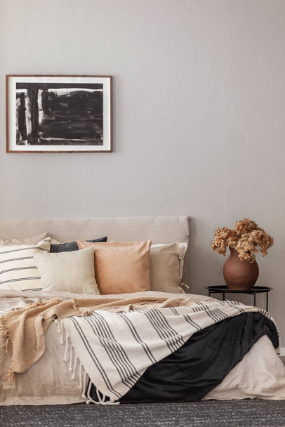 Cozy pillows on comfortable big king size bed in bright bedroom interior in elegant apartment - Φωτογραφία, εικόνα