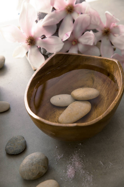 Spa and wellness. Natural massage stones , silkworm cocoon with magnolia flower .Spa treatment - Фото, изображение