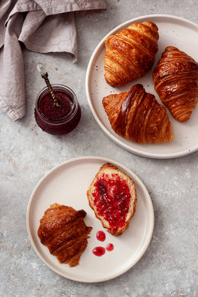 Fresh tasty homemade croissants with  raspberries jam.Tasty breakfast - Photo, Image