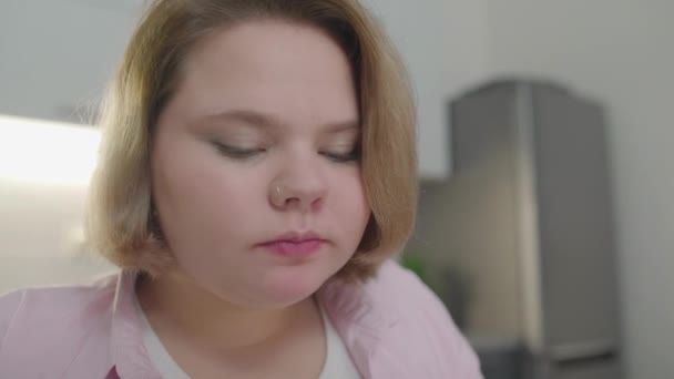Overweight young woman eating pizza and drinking soda, unhealthy nutrition - Footage, Video