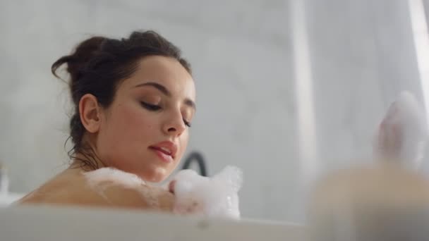Close up sensual woman blowing foam in bathtub slow motion. - Felvétel, videó
