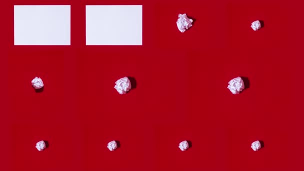 Sheets of A4 paper appear on a red background - Video