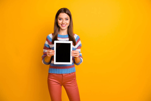 Portrait of pretty charming girl hold tablet demonstrate new modern technology recommend adverts promotion wear sweater isolated over vibrant color background - Φωτογραφία, εικόνα