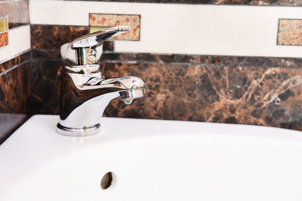Ceramic sink with chrome fixture, close up - Fotoğraf, Görsel