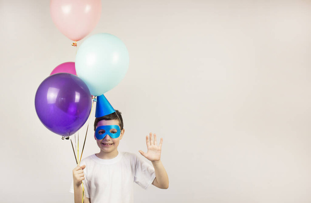 Festive balloons. Happy birthday concept. Birthday with festive colorful balloons. Joyful children. Celebrate your birthday poster. Banner. The boy in the hat and glasses. Place for text - Zdjęcie, obraz