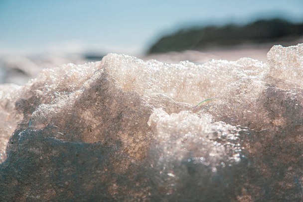 A closeup of Atlantic Ocean sea foam during wintertime on Plum Island, Massachusetts - Photo, Image