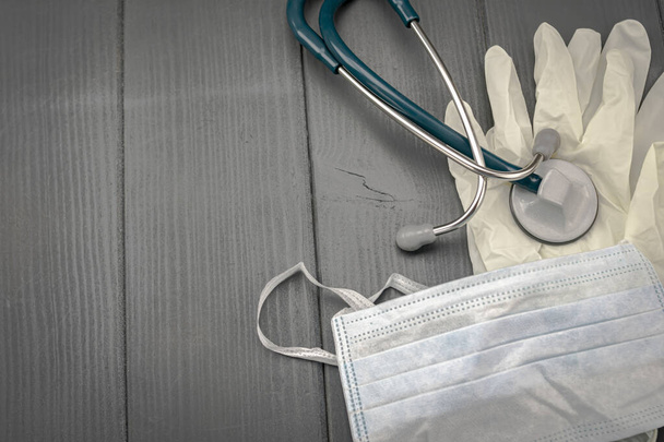 Individual protection equipment. Latex gloves, mask and stethoscope for medical use to detect viruses and bacteria - Photo, Image