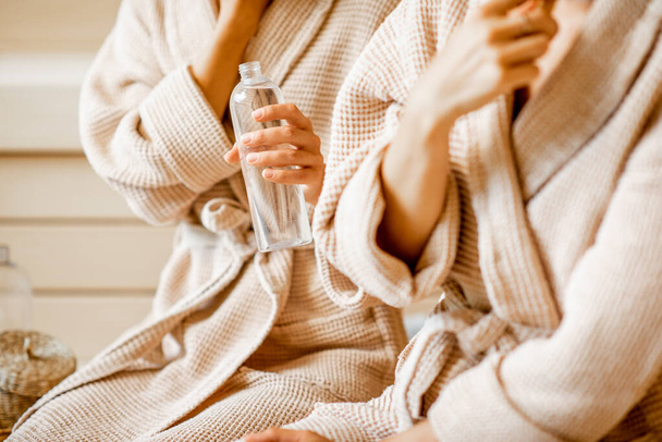 Women holding bottle in the SPA - Photo, Image