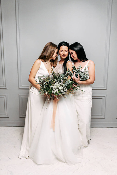 Bride and bridesmaid three together in dresses - 写真・画像