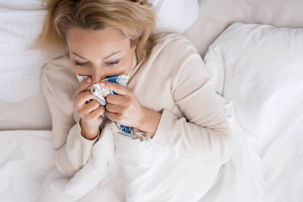 Sick woman lying in bed with high fever. Virus infection. - Foto, imagen