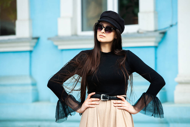 Beauty fashion portrait of young beautiful brunette girl with long black hair wearing sunglasses. Beauty russian girl face with natural skin. European glamour. Pretty hipster girl in sunglasses. - Photo, Image