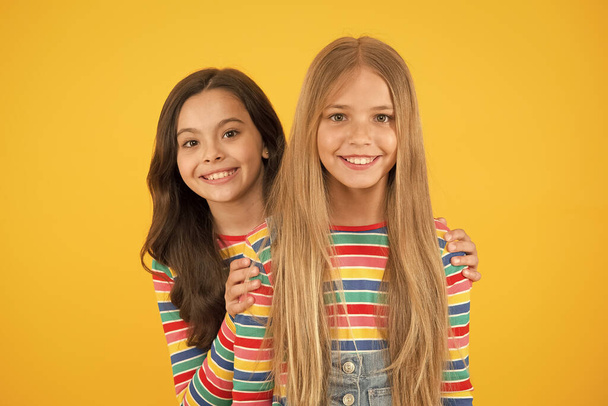 Children are the future. Happy children with long hair yellow background. Small children in casual style. Little children cute smiling. International childrens day - Foto, immagini